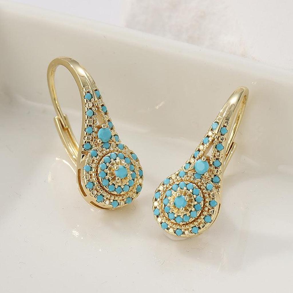 Puces d’oreilles dorées à éléments turquoise