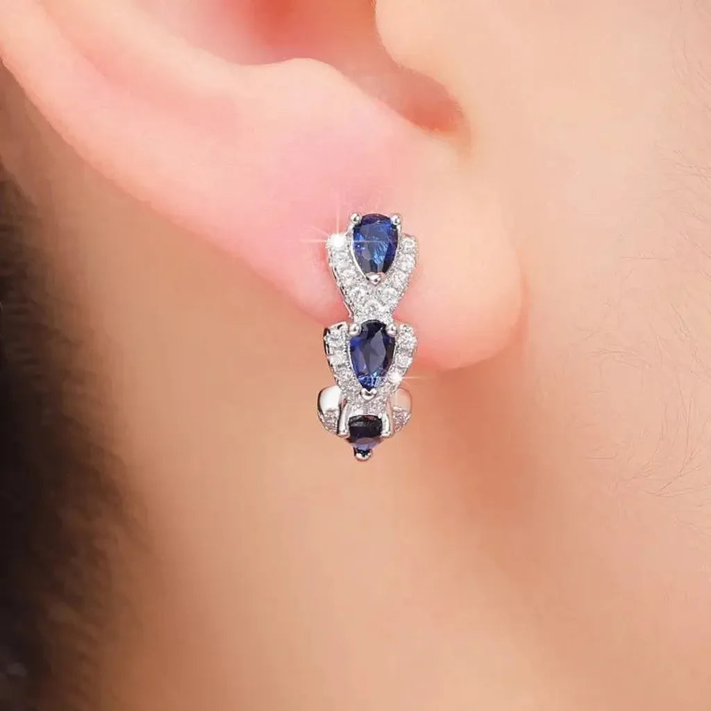 Boucles d’oreilles royales à blason et pierres bleues